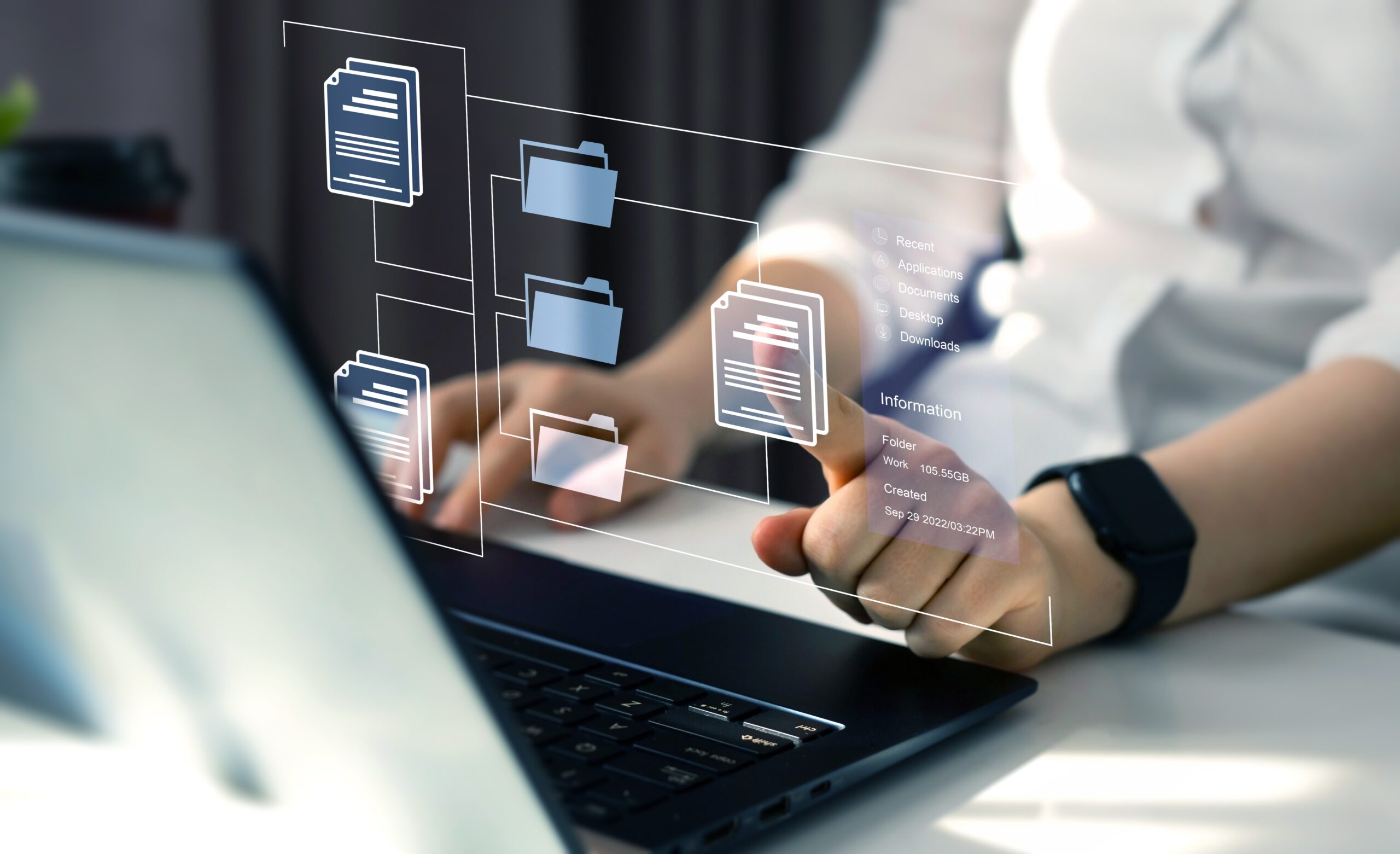 Digital File Management Interface – A woman uses a laptop with virtual folder and file graphics floating above.